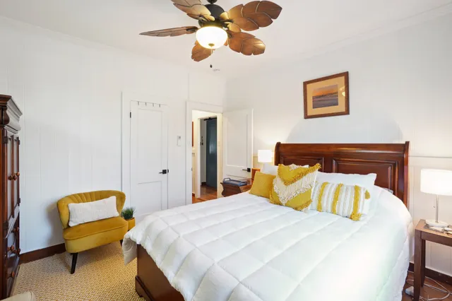 a bedroom with a bed and lamp