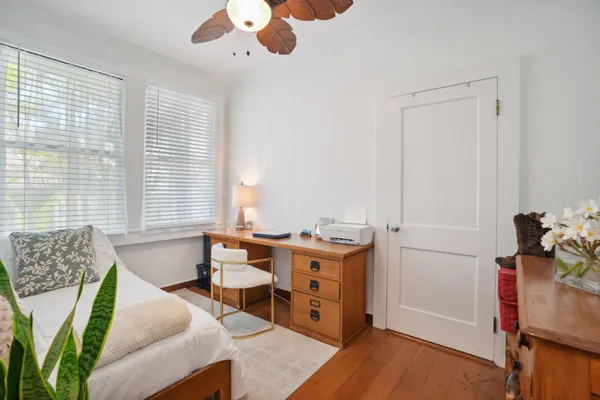 a view of a bedroom with furniture and a window
