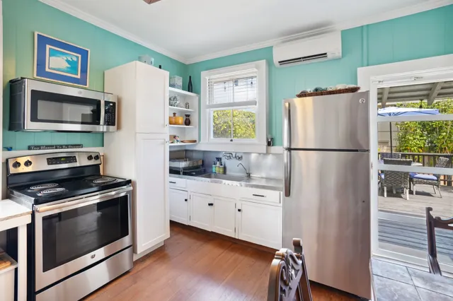 a kitchen with stainless steel appliances a refrigerator stove and microwave