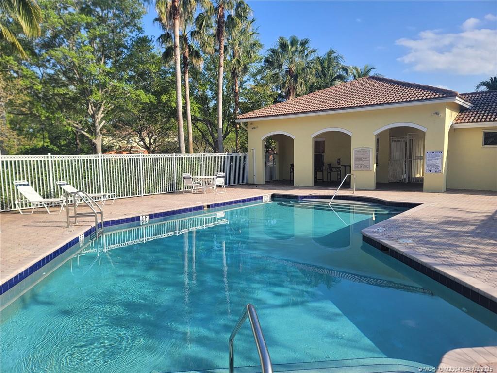 a swimming pool with patio outdoor seating and yard