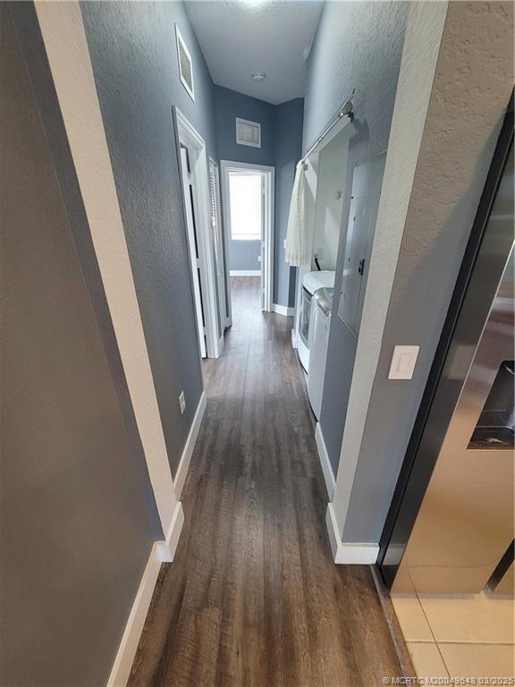 59 Southeast Palermo, Unit 204 Stuart, FL 34994 - Photo 6 of 23 a view of a hallway with wooden floor and staircase