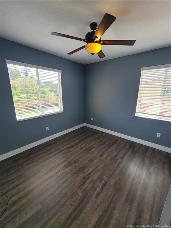 59 Southeast Palermo, Unit 204 Stuart, FL 34994 - Photo 8 of 23 an empty room with wooden floor and windows