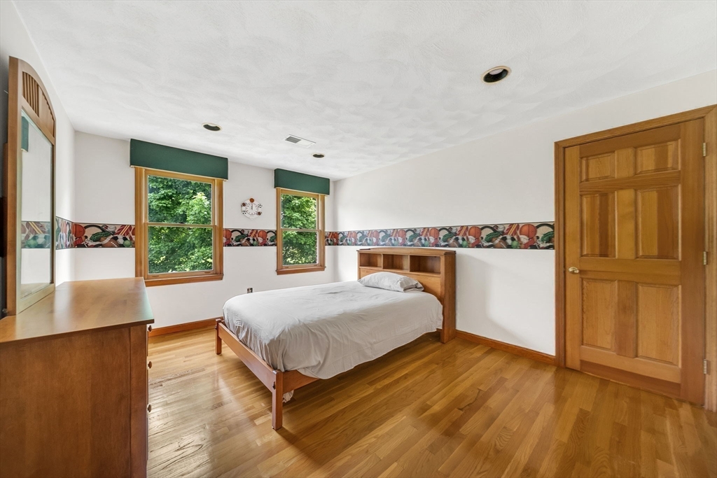 83 Jefferson Road Franklin, MA 02038 - Photo 18 of 34 a spacious bedroom with a bed and wooden floor