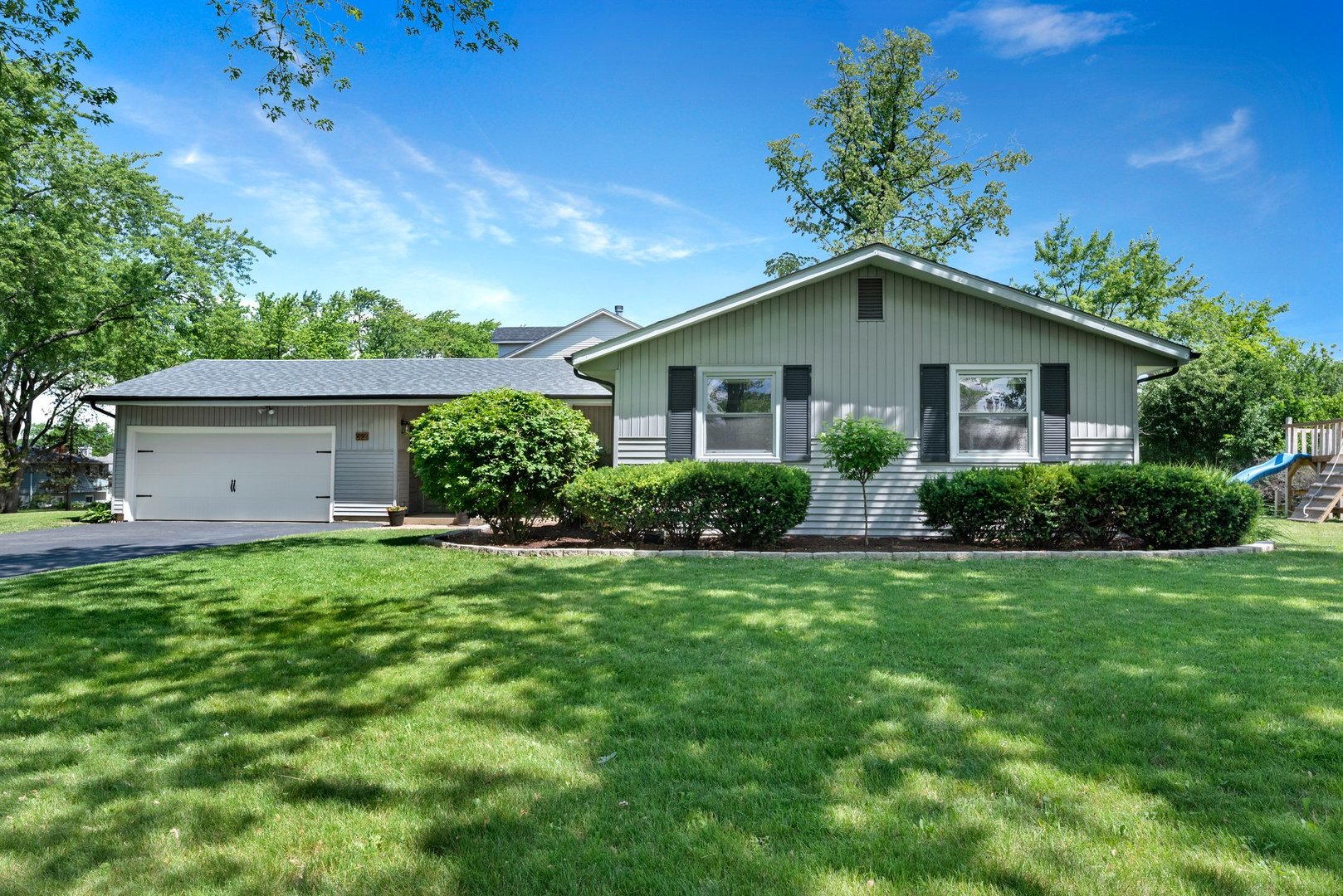 623 Ranch Road Wheaton, IL 60187 - Photo 1 of 21 a front view of house with a garden