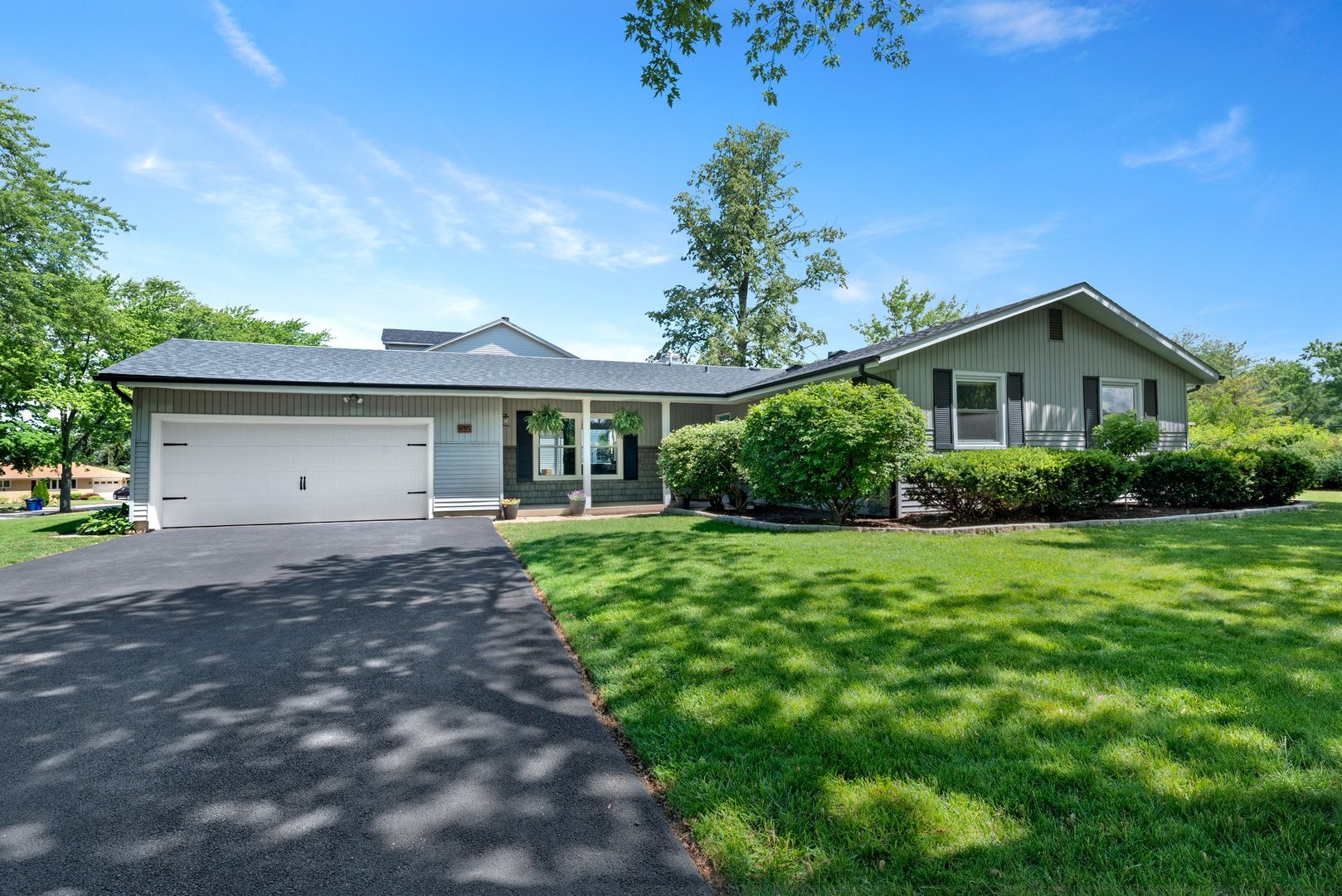 623 Ranch Road Wheaton, IL 60187 - Photo 2 of 21 a front view of a house with a garden and plants