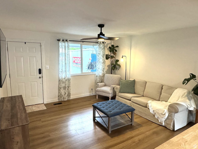 1791 West 170 South, Unit 8 Provo, UT 84601 - Photo 14 of 25 Living area featuring wood-finish flooring, a white paneled entry door, and a ceiling fan