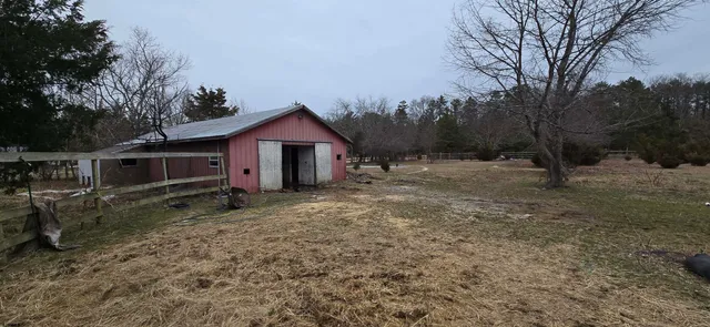 a view of a house with a yard covered in snow