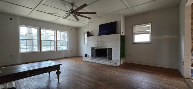 a living room with furniture fireplace and window