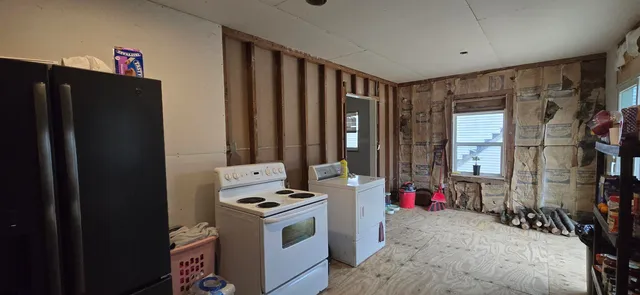 a kitchen that has a refrigerator and a stove