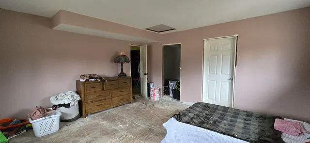 a bedroom with a bed and a dresser