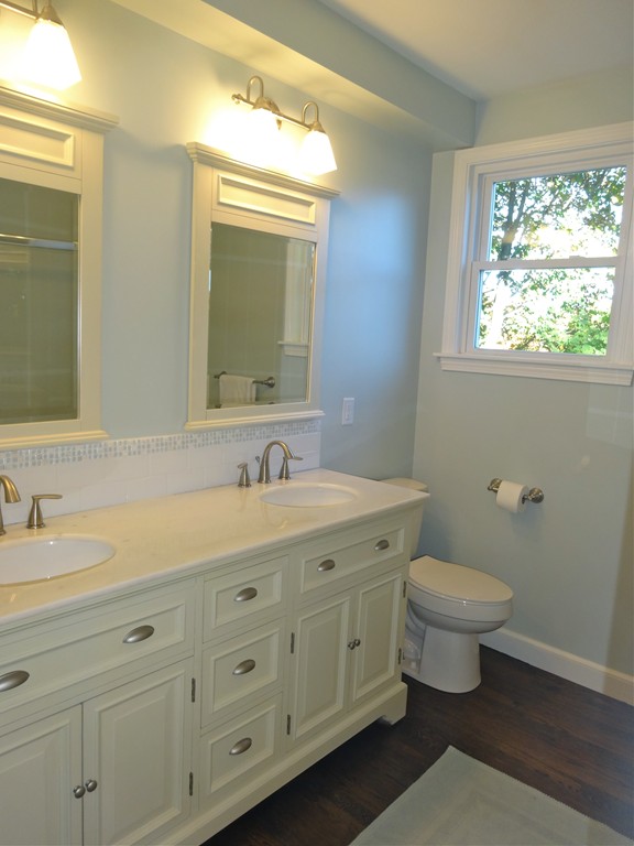 9 Summit Drive Hingham, MA 02043 - Photo 19 of 28 a bathroom with a granite countertop toilet a double vanity sink a mirror and a window