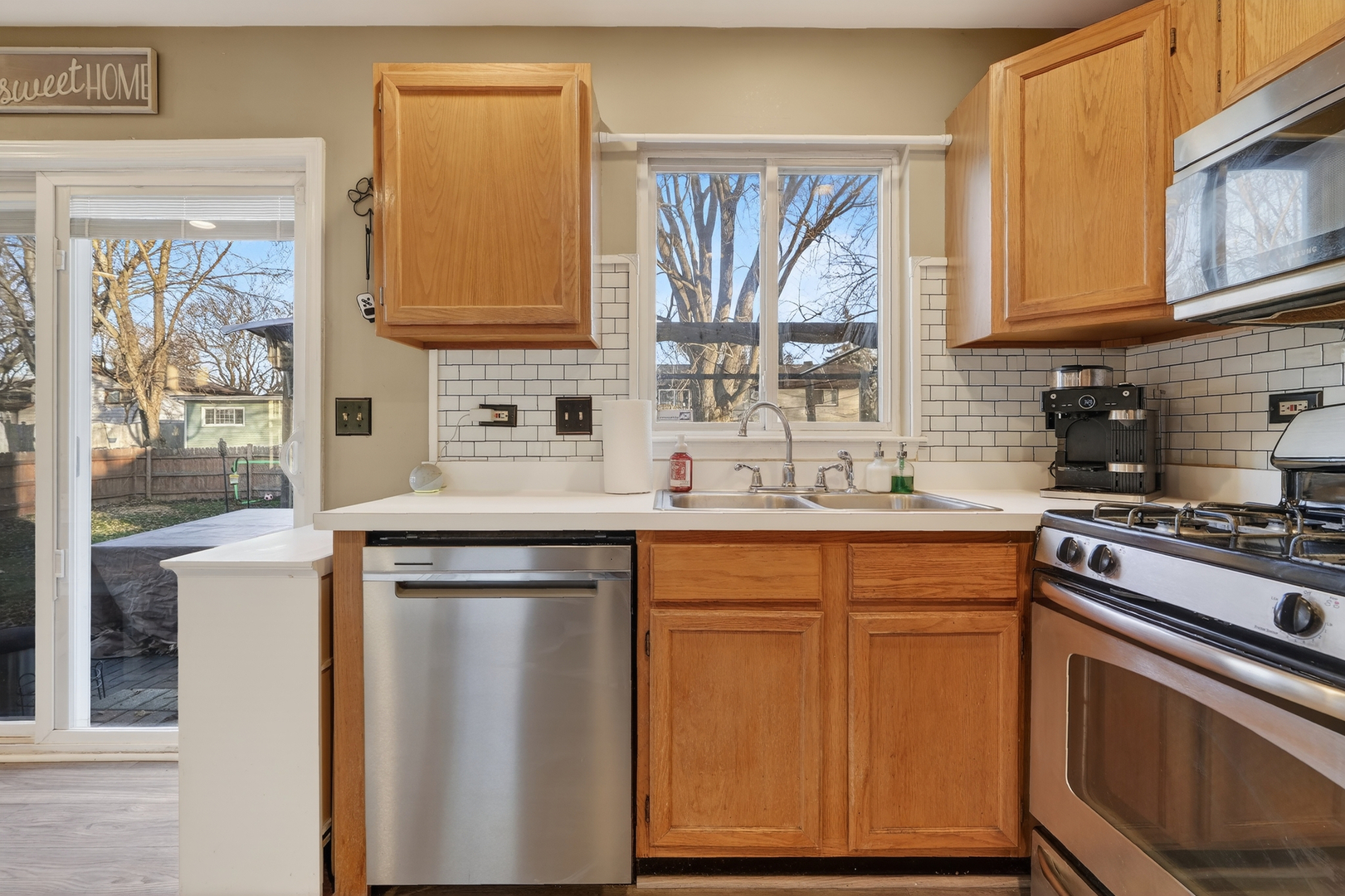771 Eletson Drive Crystal Lake, IL 60014 - Photo 9 of 32 a kitchen with stainless steel appliances granite countertop a sink stove and refrigerator