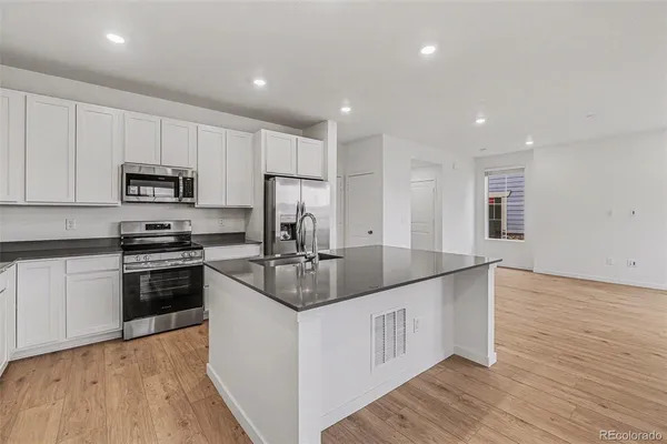 a kitchen with stainless steel appliances granite countertop a granite counter tops and a stove