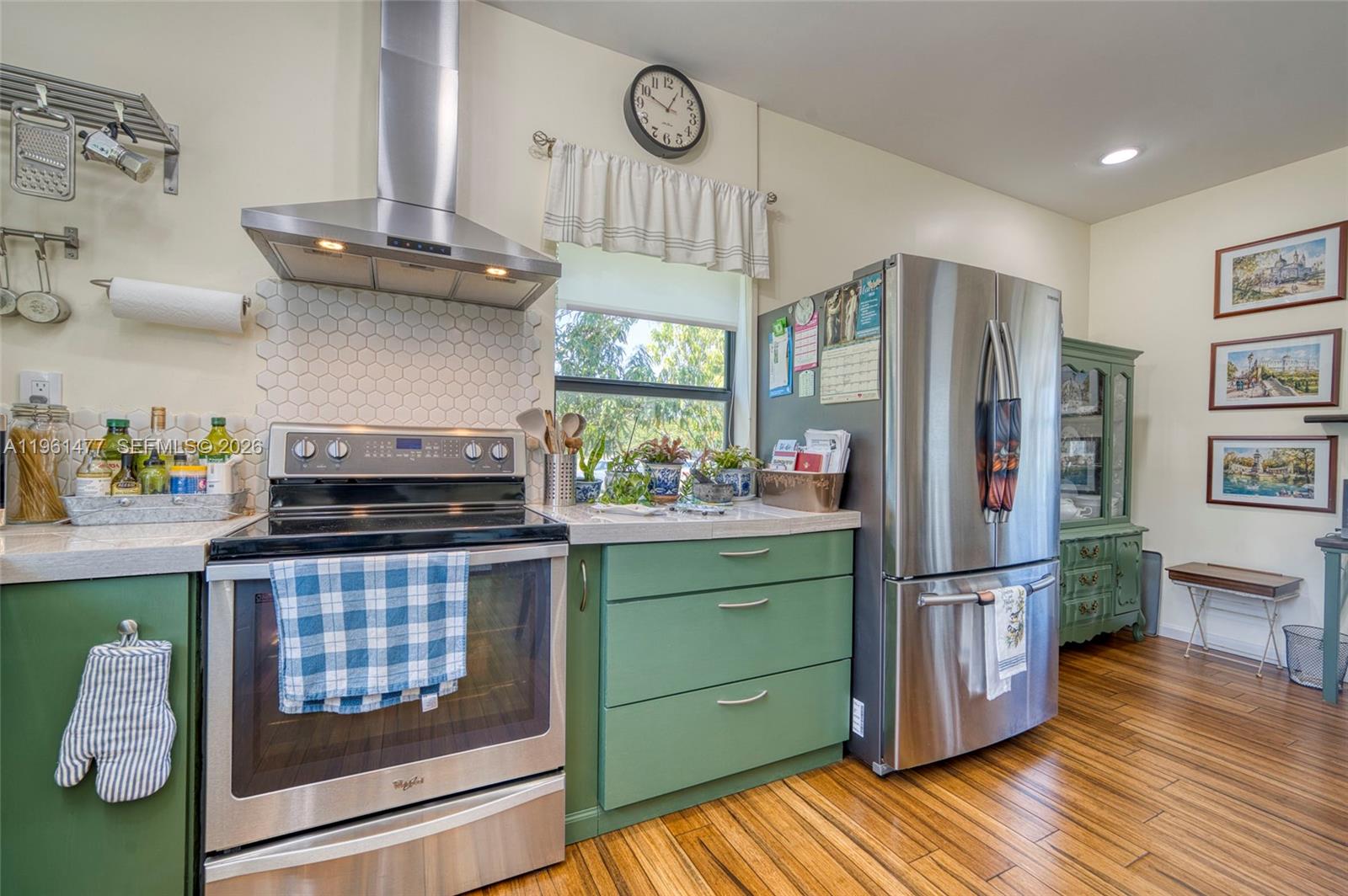 18860 Southwest 354th Terrace Homestead, FL 33034 - Photo 16 of 54 a kitchen with stainless steel appliances granite countertop a refrigerator a stove and a wooden floors