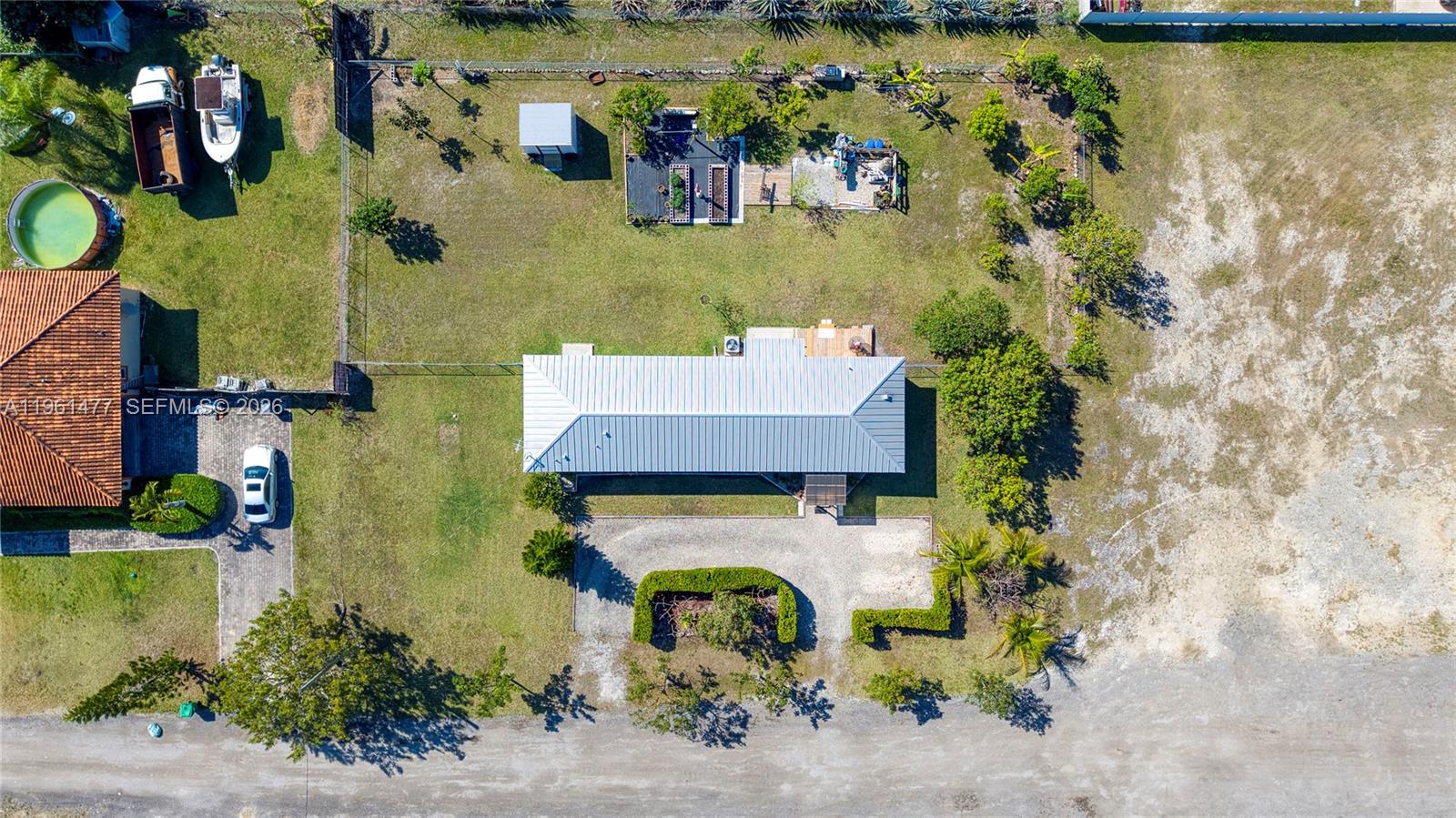 18860 Southwest 354th Terrace Homestead, FL 33034 - Photo 6 of 54 an aerial view of a house with a yard and lake view
