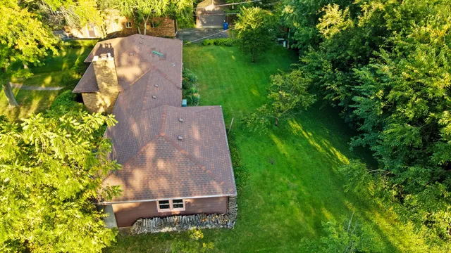 an aerial view of a house with a yard