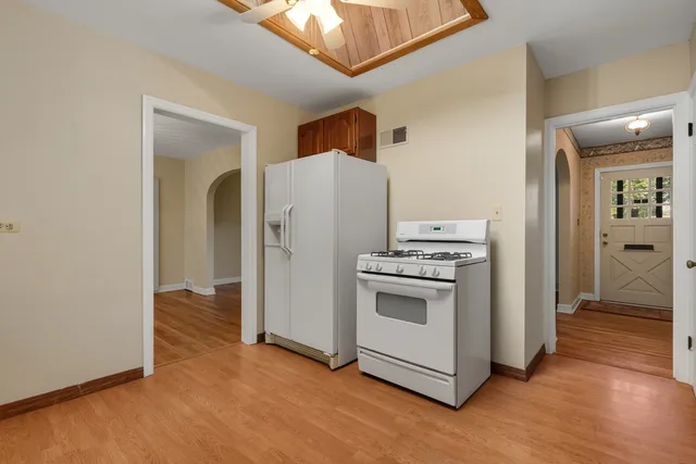 a kitchen with a refrigerator and a stove