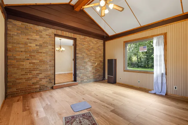 a view of a room with wooden floor and windows