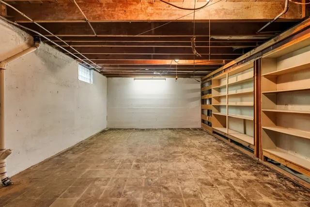 a view of an empty room with a staircase