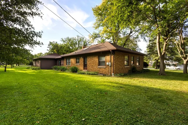 a front view of house with yard and green space