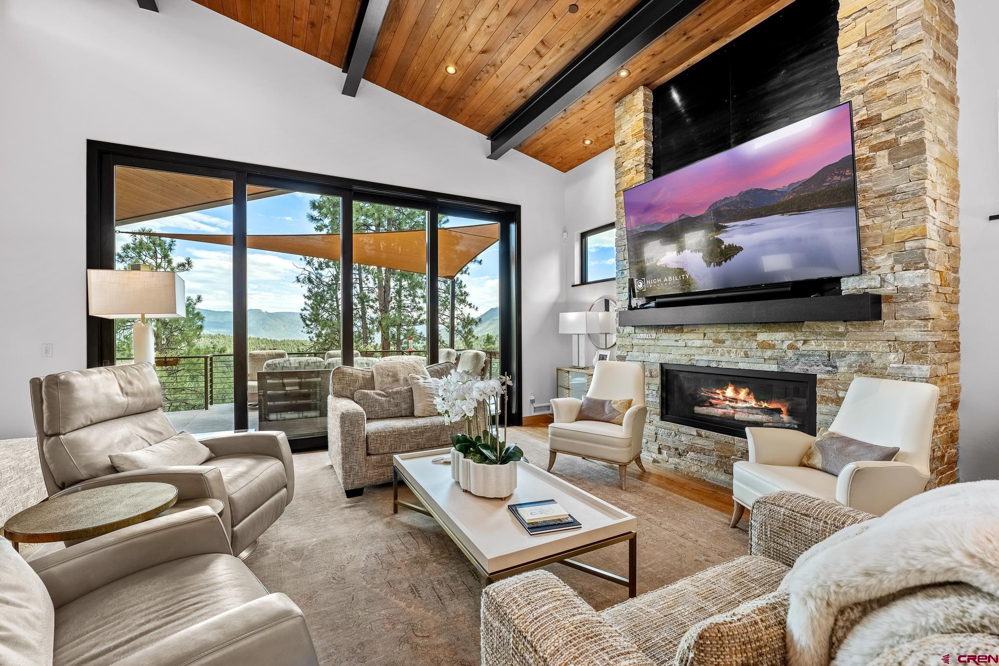 220 Hideout Trail Durango, CO 81301 - Photo 14 of 35 a living room with furniture a fireplace and a flat screen tv
