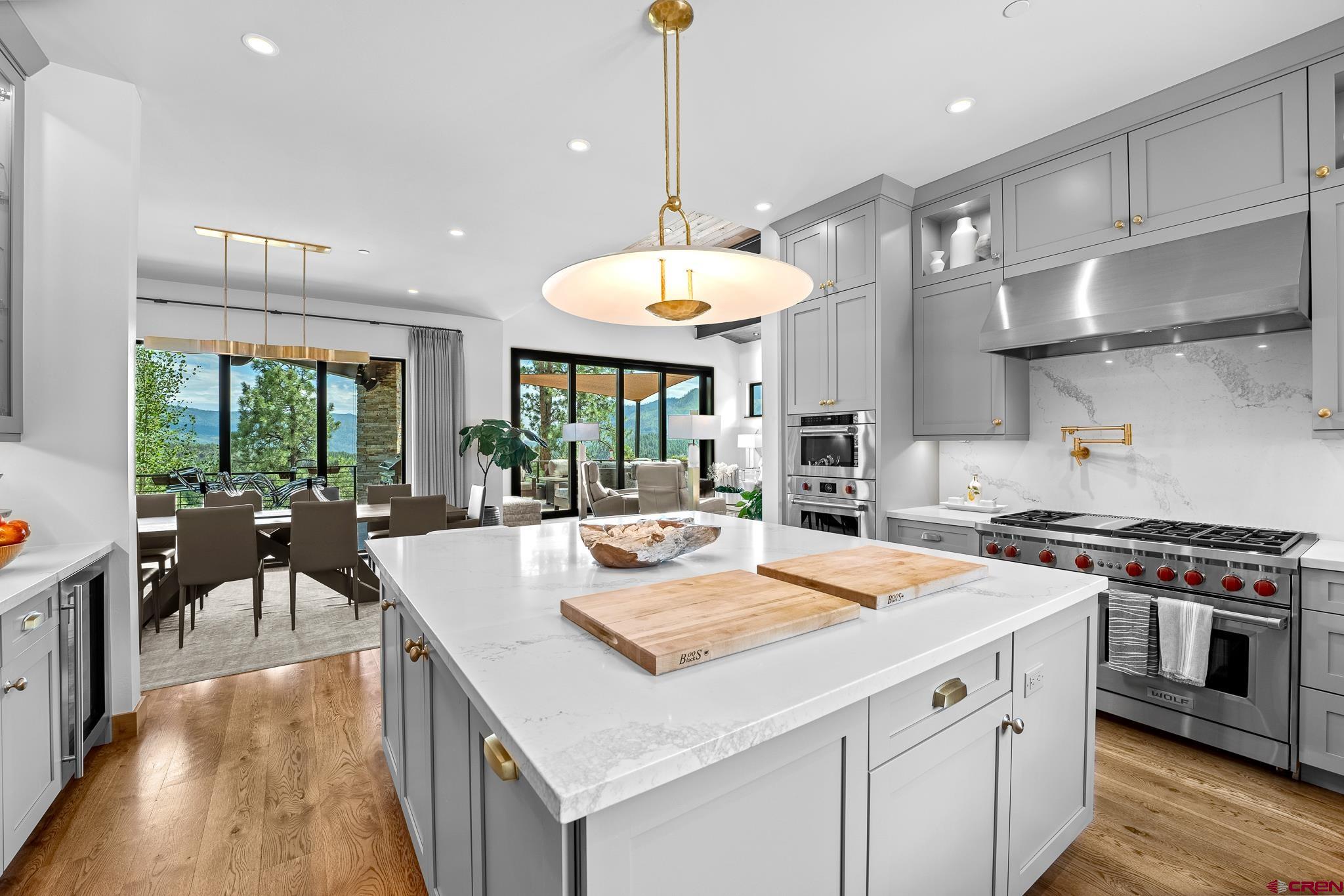 220 Hideout Trail Durango, CO 81301 - Photo 17 of 35 a kitchen with stainless steel appliances granite countertop a stove and a table