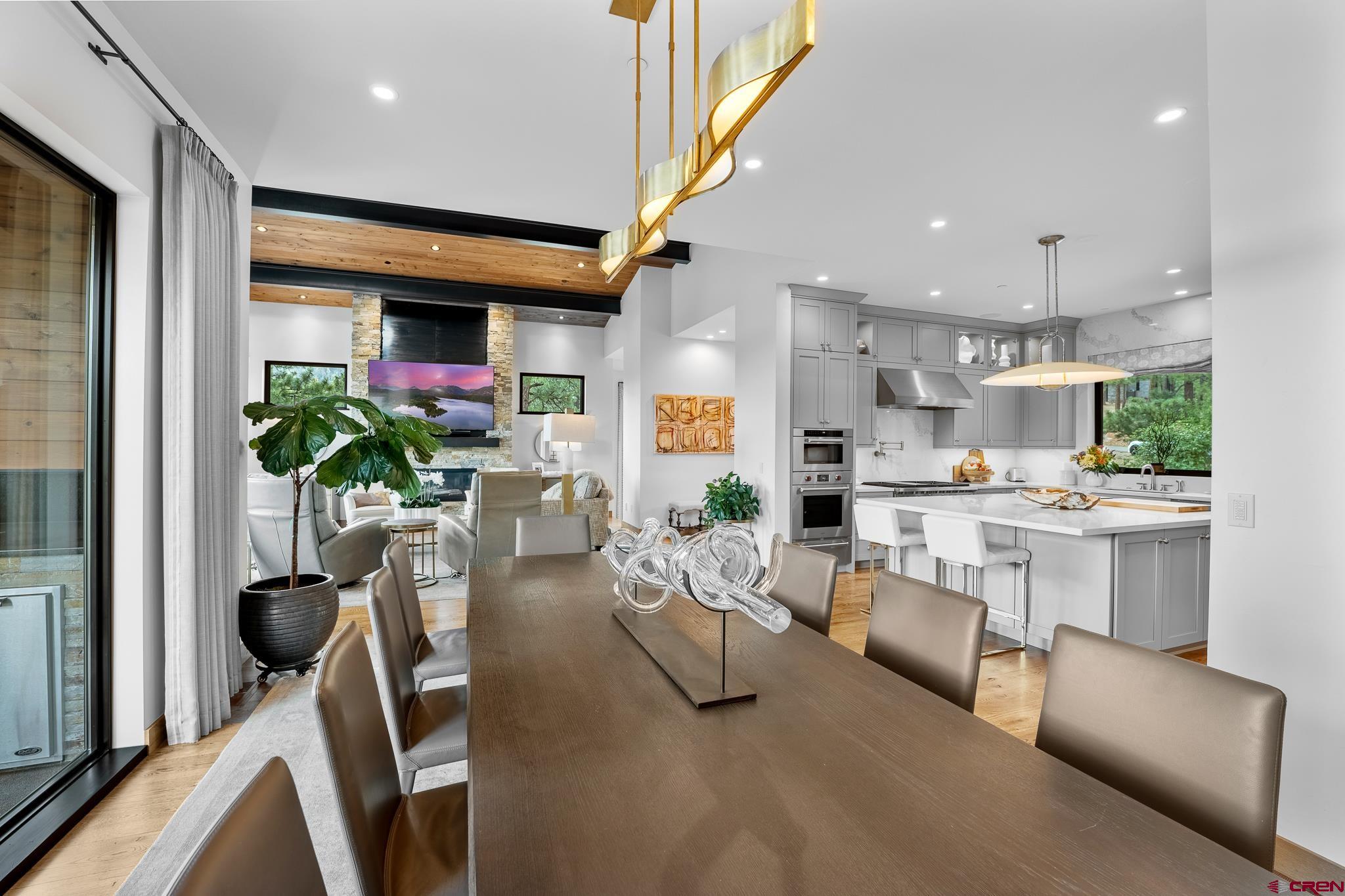 220 Hideout Trail Durango, CO 81301 - Photo 18 of 35 a living room with furniture a potted plant and a kitchen view