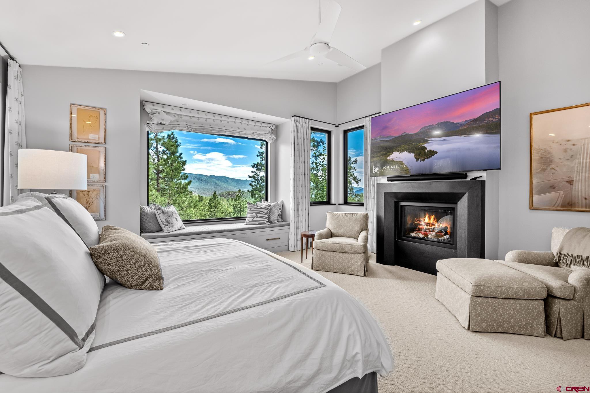 220 Hideout Trail Durango, CO 81301 - Photo 23 of 35 a bed room with a bed and a fireplace