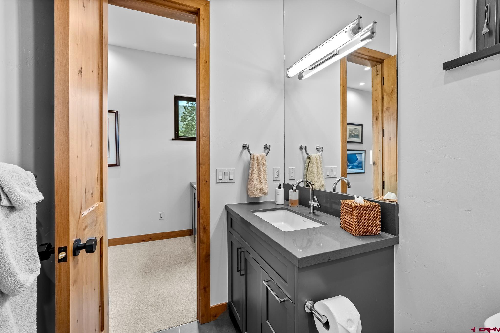 220 Hideout Trail Durango, CO 81301 - Photo 29 of 35 a bathroom with a sink vanity and a mirror