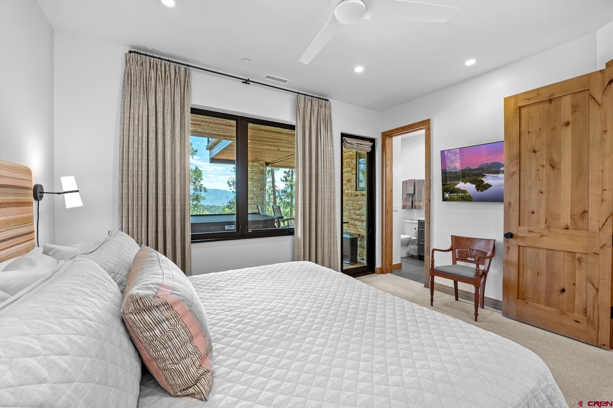 220 Hideout Trail Durango, CO 81301 - Photo 31 of 35 a bedroom with a bed and a large mirror