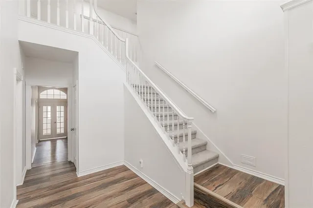 a view of entryway and hall with wooden floor