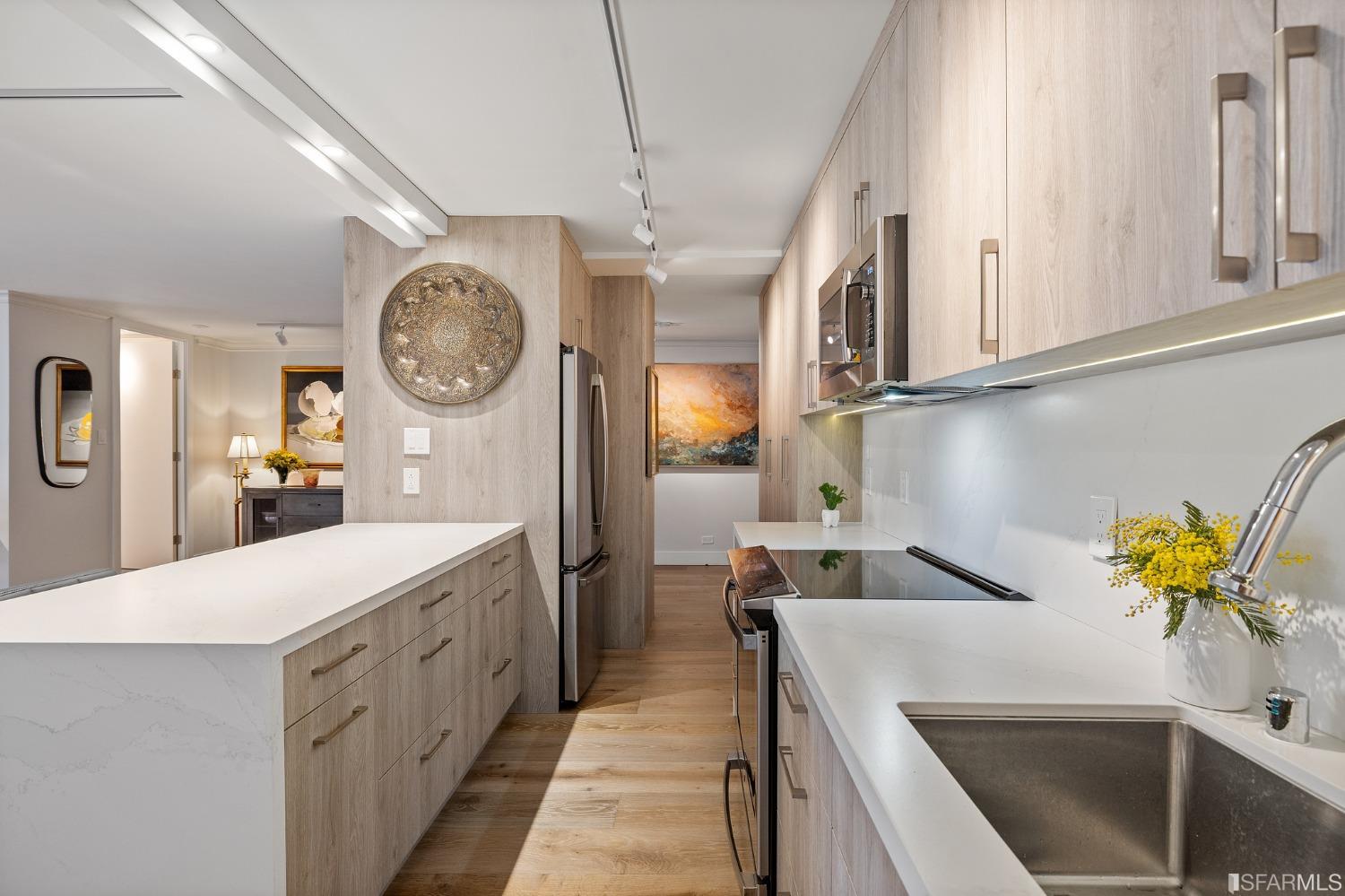 2200 Pacific Avenue, Unit 3A San Francisco, CA 94115 - Photo 15 of 57 a kitchen with a sink a clock and cabinets