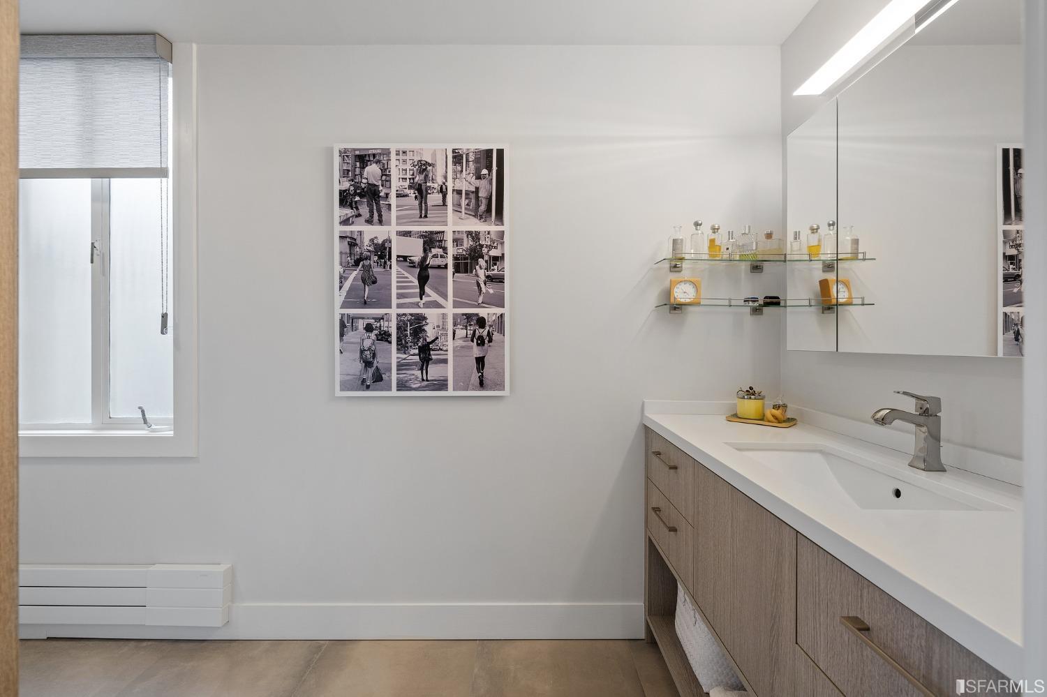 2200 Pacific Avenue, Unit 3A San Francisco, CA 94115 - Photo 21 of 57 a bathroom with a sink and a mirror