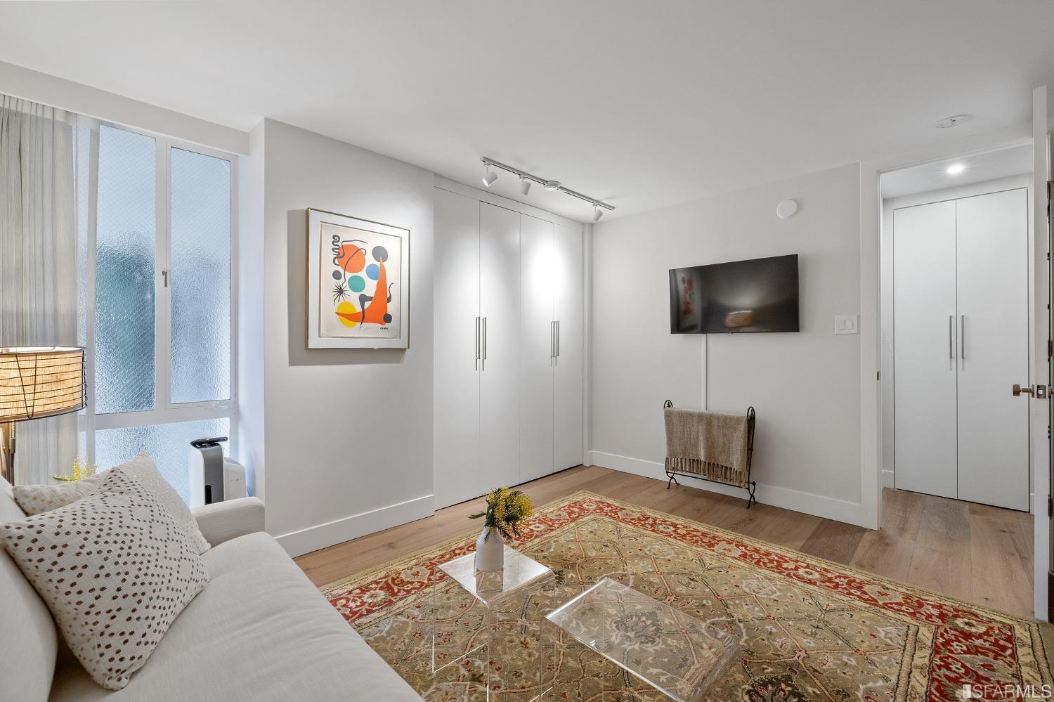 2200 Pacific Avenue, Unit 3A San Francisco, CA 94115 - Photo 26 of 57 a bedroom with a bed and a flat screen tv