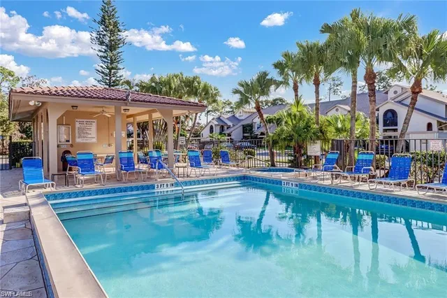 a view of a house with a swimming pool and a chairs