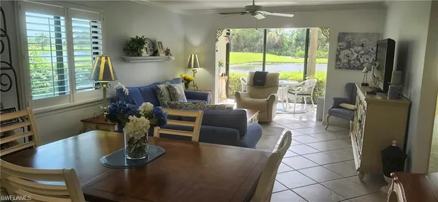a living room with furniture large window and flat screen tv