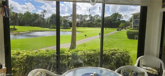 a view of a balcony with chair and floor to ceiling window