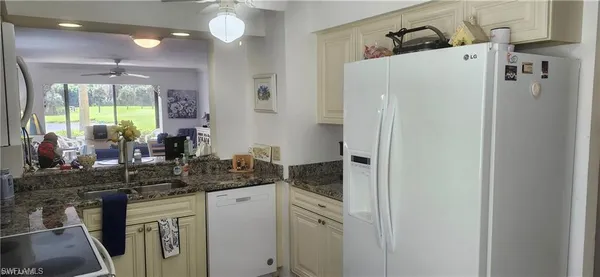 a kitchen with a refrigerator and a sink