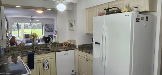 a kitchen with a refrigerator and a sink