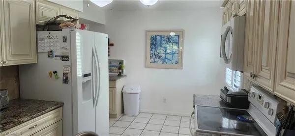 a kitchen with stainless steel appliances granite countertop a refrigerator and a stove