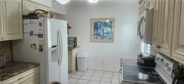 a kitchen with stainless steel appliances granite countertop a refrigerator and a stove