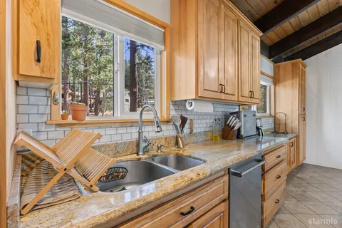 a kitchen with a sink a counter top space and cabinets