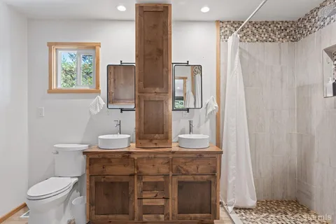 a bathroom with a sink toilet and a mirror