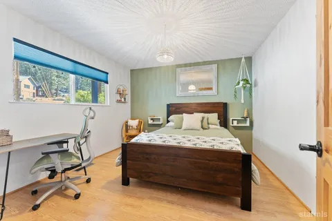 a bedroom with a bed and a desk