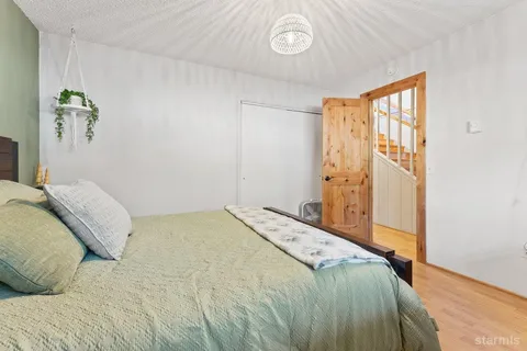 a bedroom with a bed and a window