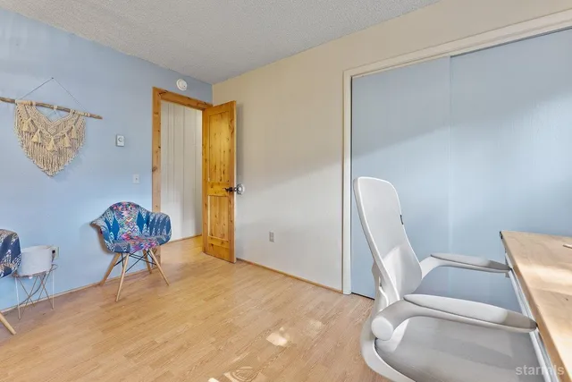 a bedroom with a bed and a chair