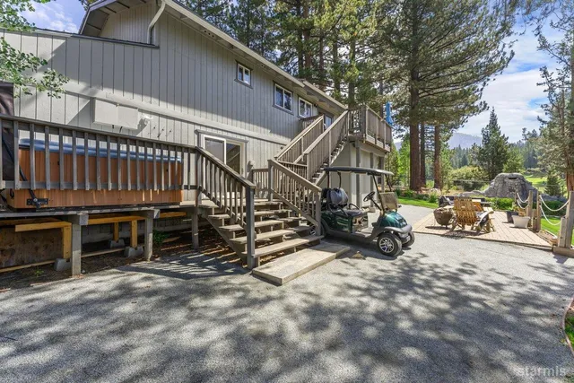 a view of a house with a patio and a yard