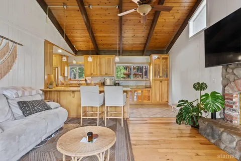 a living room with furniture a flat screen tv and a potted plant