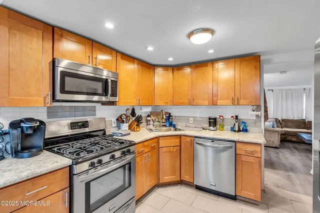 a kitchen with a stove a sink and a microwave