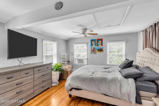 a bedroom with a large bed and a flat screen tv